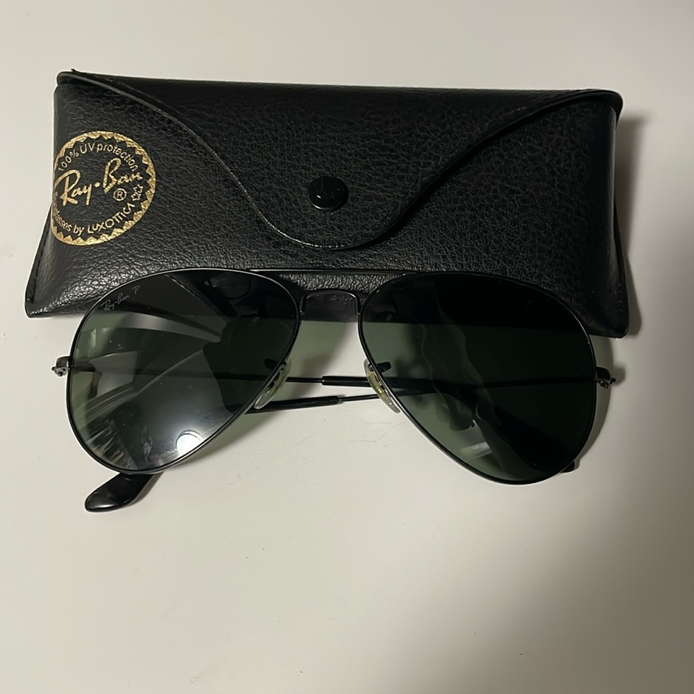 Black aviator Ray Ban polarized sunglasses, one arm is slightly crooked